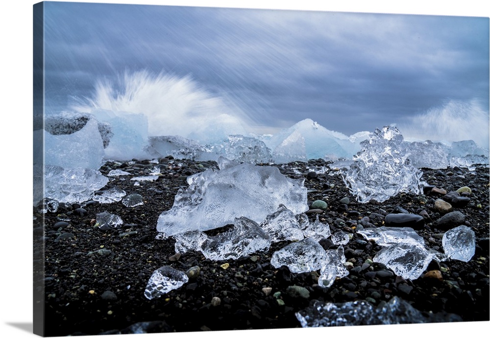 Water crashing over the ice and black sandy beach at Jokulsarlon, Iceland, Polar Regions