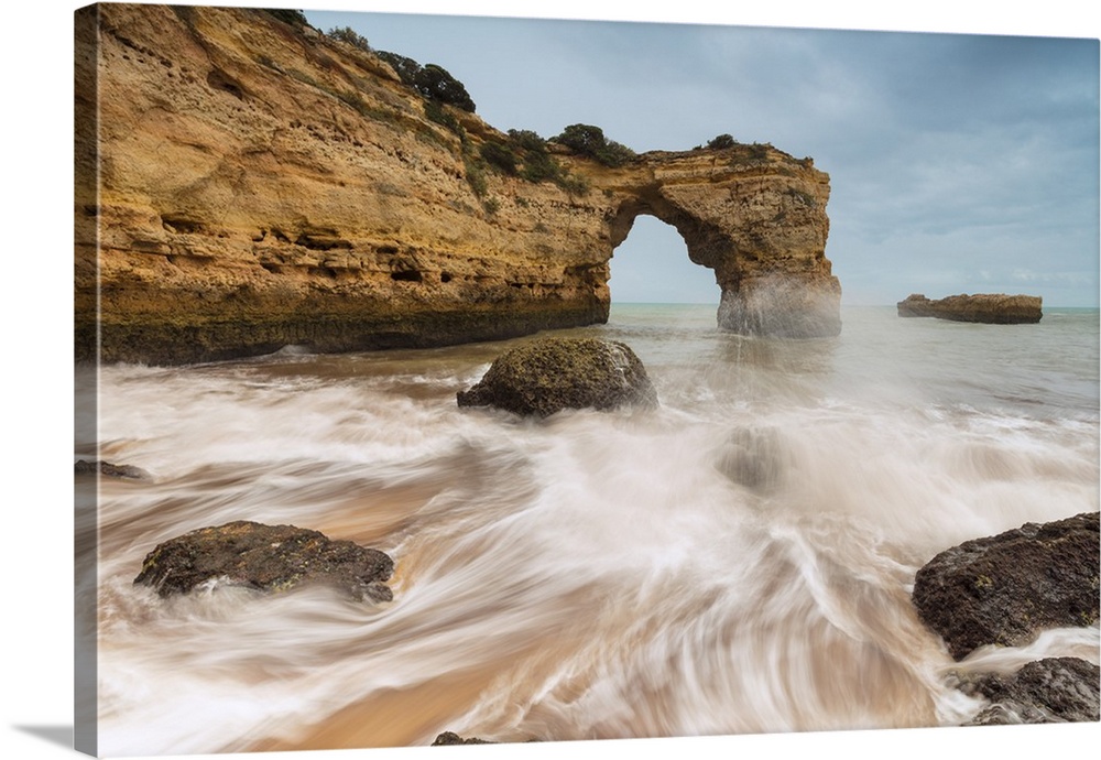 Waves crashing on the sand beach surrounded by cliffs, Albandeira, Lagoa Municipality, Algarve, Portugal