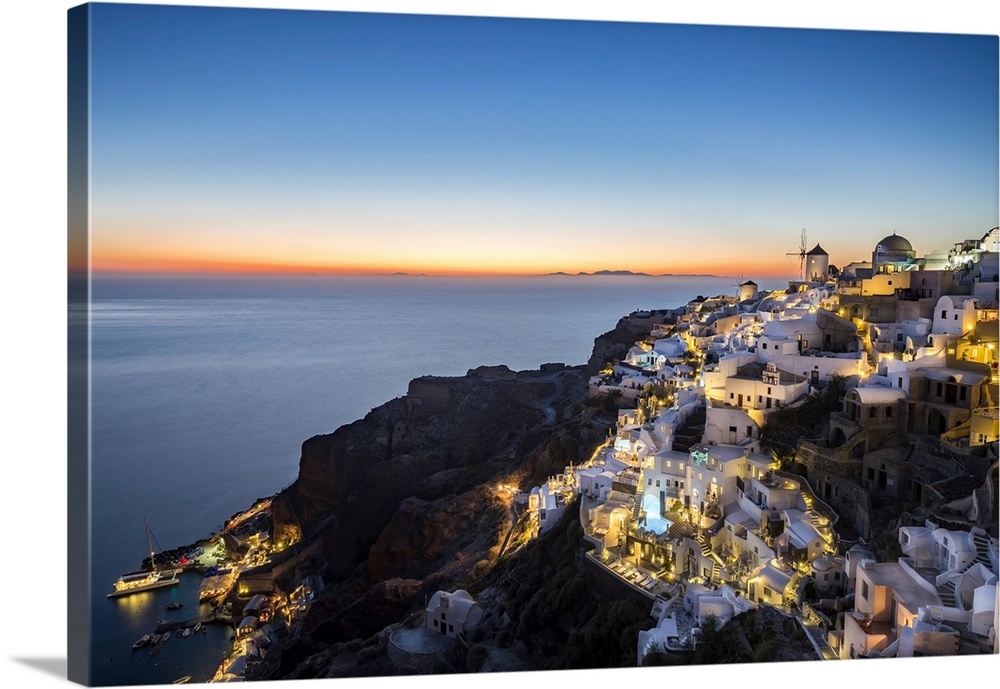 Long exposure sunset view over the whitewashed buildings and windmills of Oia, Santorini, Cyclades, Greek Islands, Greece,...