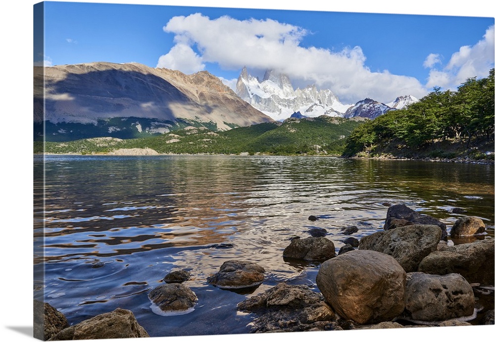 Wide angle shot of Capri Lagoon featuring Monte Fitz Roy in the background and rocks in the foreground, Patagonia, Argenti...