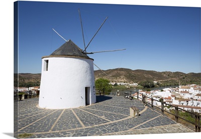 Windmill above village and Rio Guadiana river with view to Portugal