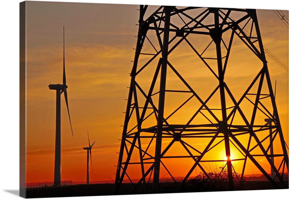 Windmills, pylon and power lines in morning light, Germany