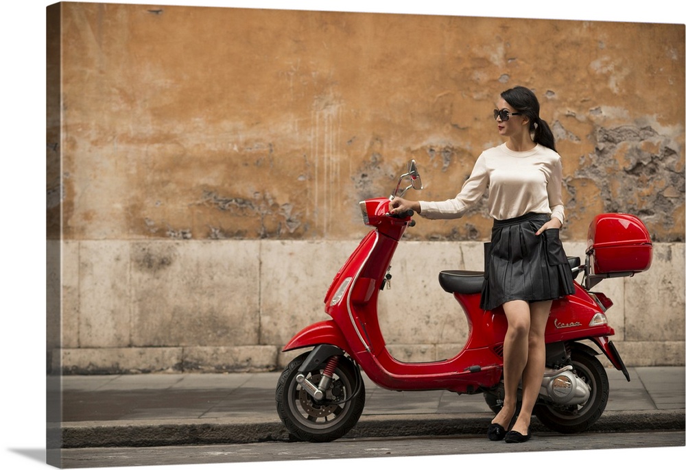 Young woman waiting by Vespa moped, Rome, Lazio, Italy, Europe
