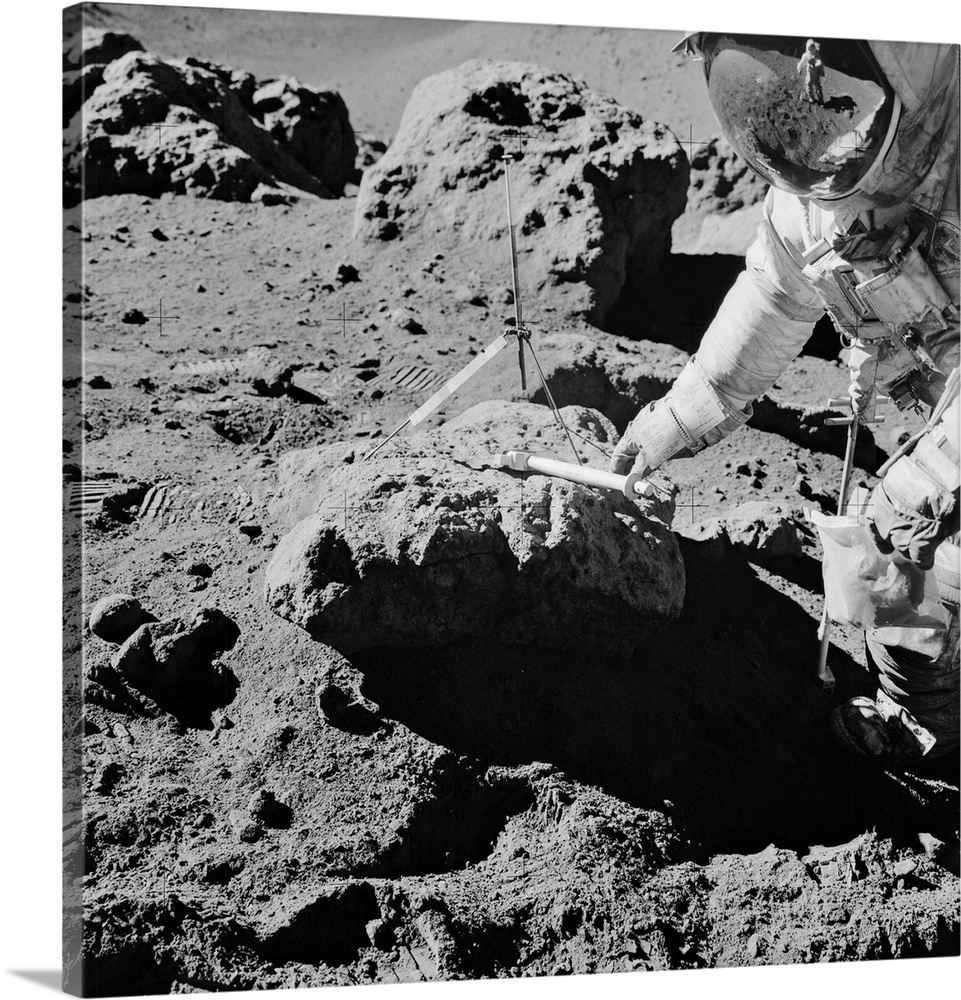 Apollo 15 lunar rock sampling, August 1971. US astronaut David Scott reaching for the geology hammer he has been using to ...