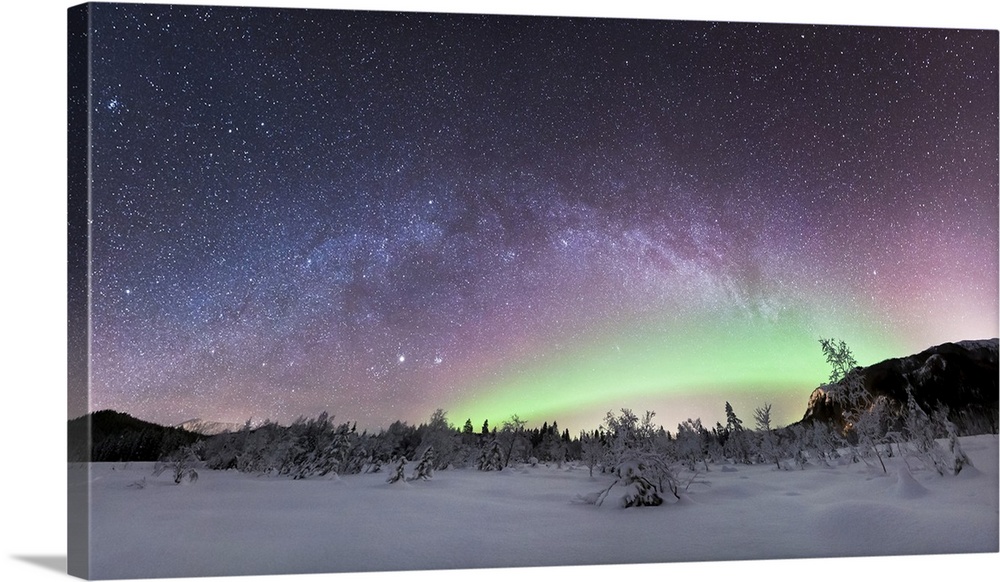 Aurora borealis and Milky Way. View of the aurora borealis (northern lights) and the Milky Way over a snow-covered landsca...