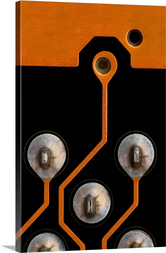 Circuit board. Light micrograph of tin contacts and tracks (orange)on a multilayer printed circuit board (PCB). These cont...