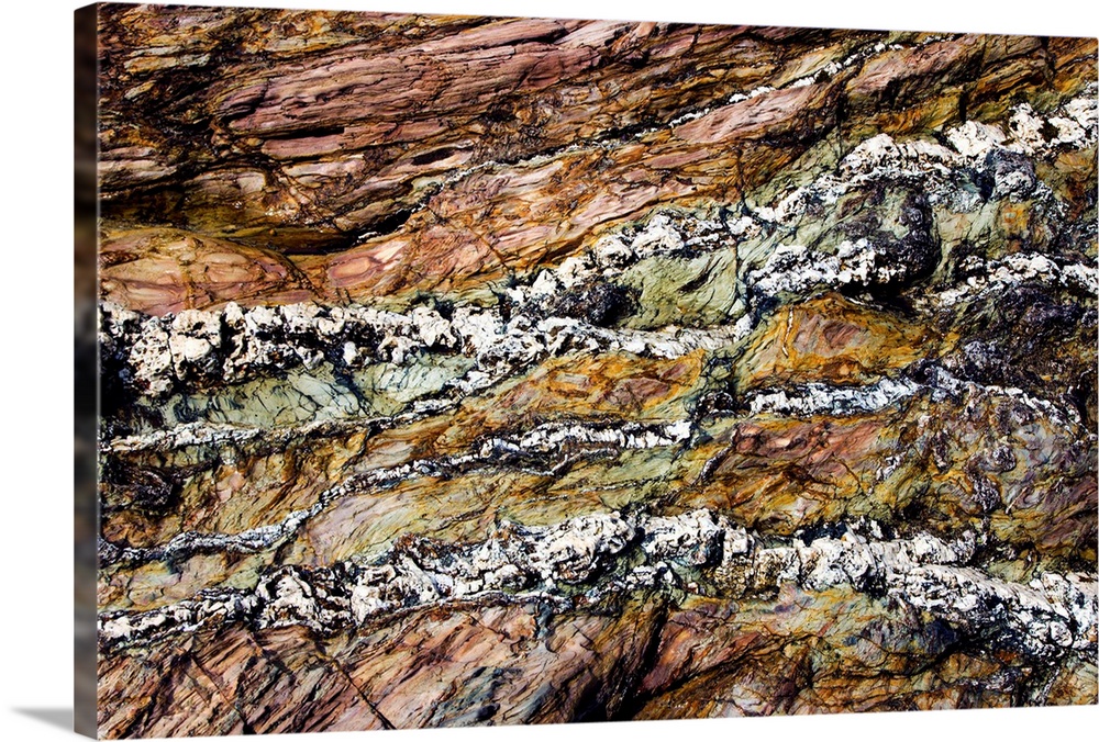 Coloured coastal rock. These colourful streaks result from the deposition and compression of coloured sediment during the ...