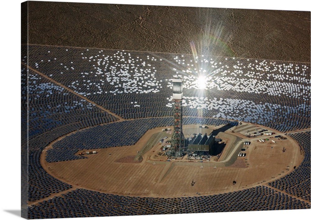 Concentrating solar power plant. Heliostat (mirrors with sun-tracking motion) arrays and receiver tower at a concentrating...