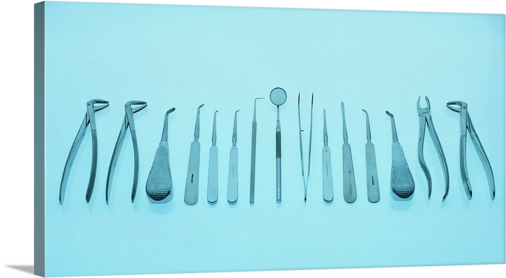 Dental equipment laid out in a row. At far right and far left are two sets of pliers for removing teeth. At centre is an a...