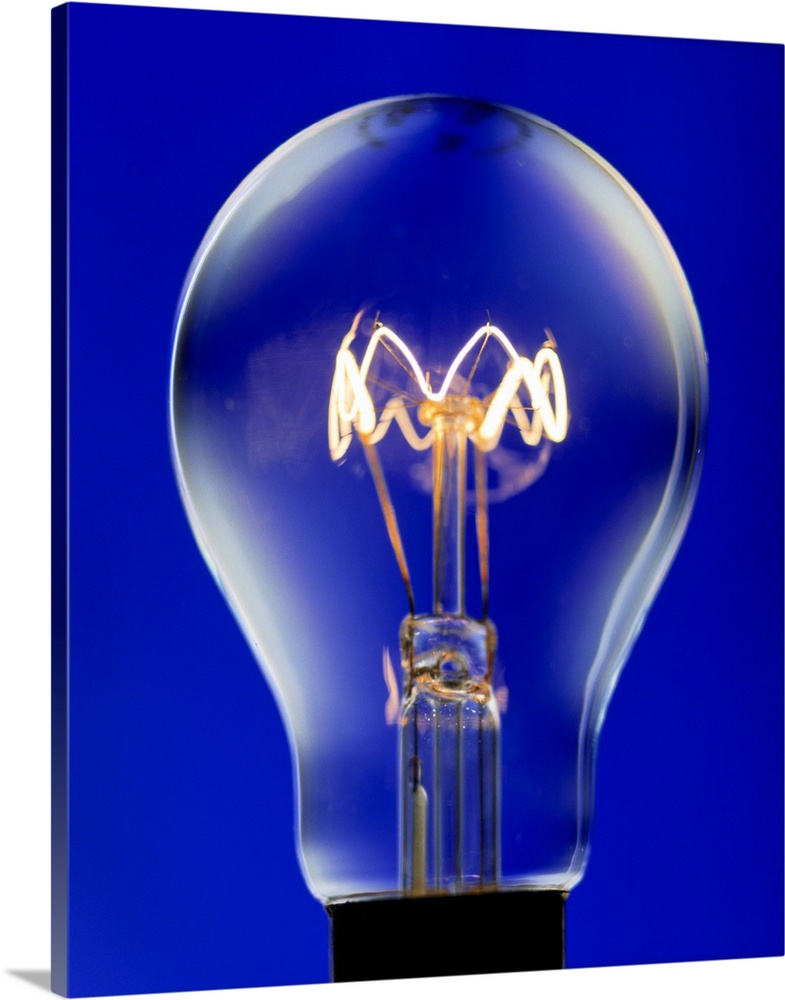 Electric light bulb. Light bulbs produce light from a filament (centre), a fine coiled wire of tungsten, which heats up an...