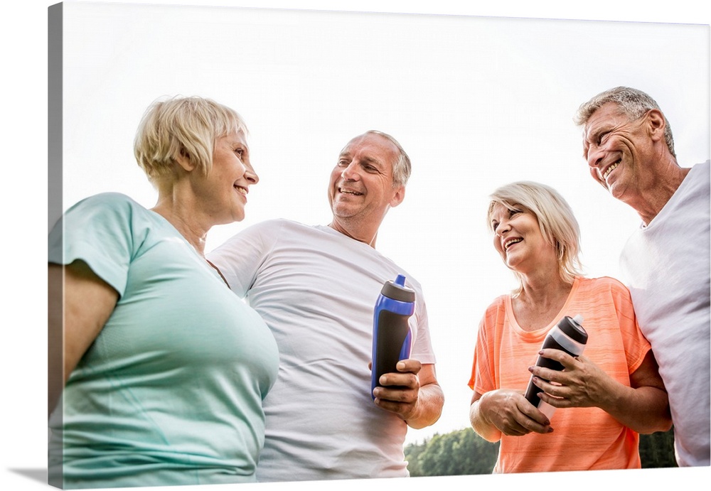 Four people outdoors with water bottles.