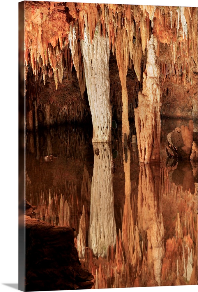 Meramec Caverns. Limestone pillars, stalagtites and stalagmites by an underground stream. The Meramec caverns are an ancie...