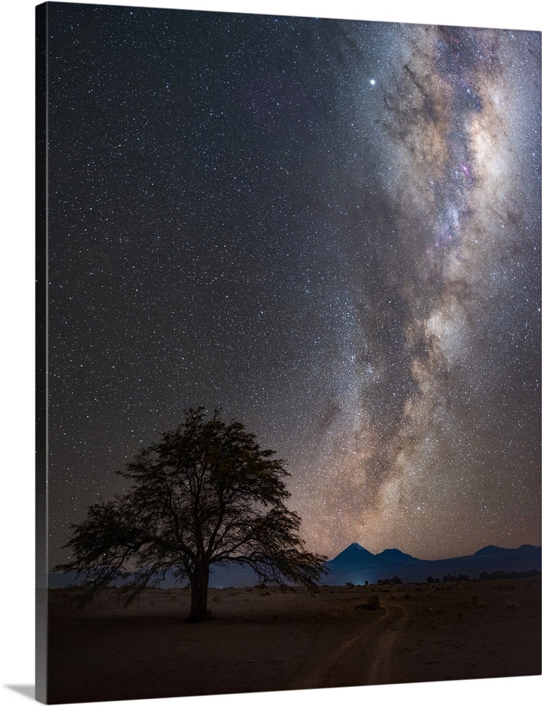 Milky Way in the night sky over the desert village of San Pedro de Atacama, Chile. The galaxy is illuminating the Licancab...