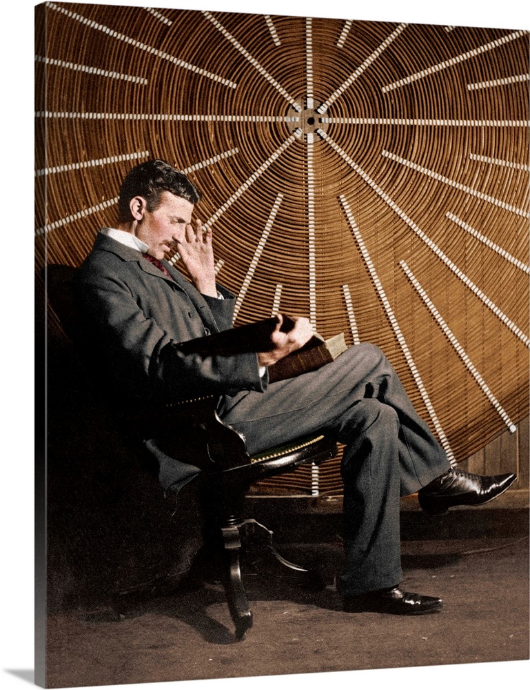 Nikola Tesla (1856-1943), Serb-US physicist, seated in front of the spiral secondary coil of a high frequency transformer ...