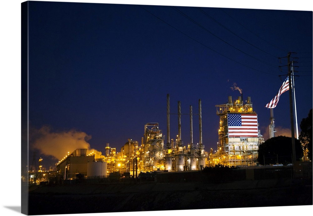 Oil refinery, displaying a huge American flag. Photographed in Wilmington, California, Los Angeles, USA.