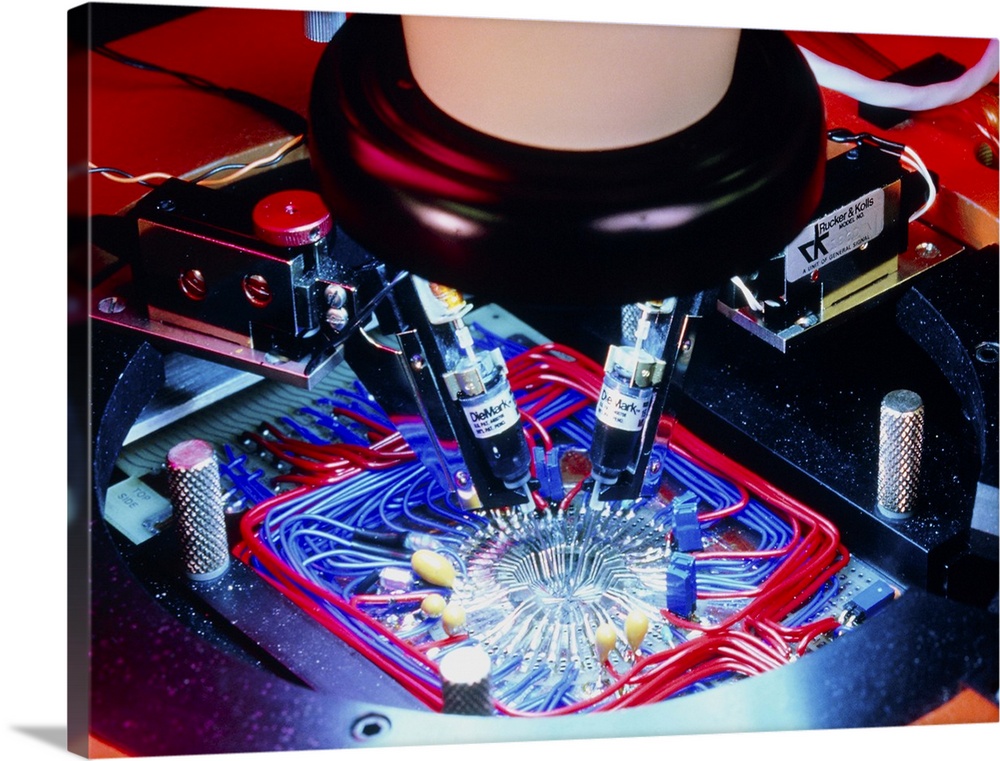 Quality control stage in the fabrication of silicon-based integrated circuit wafers, showing a close-up of a probe which a...