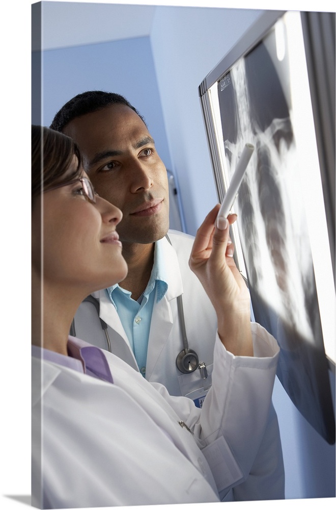 MODEL RELEASED. Radiologists studying an X-ray of a patient's chest.