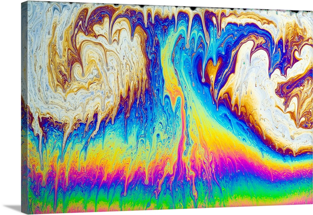 Soap film patterns. When white light is shone on a soap film (a thin mix of soap and water), coloured interference pattern...
