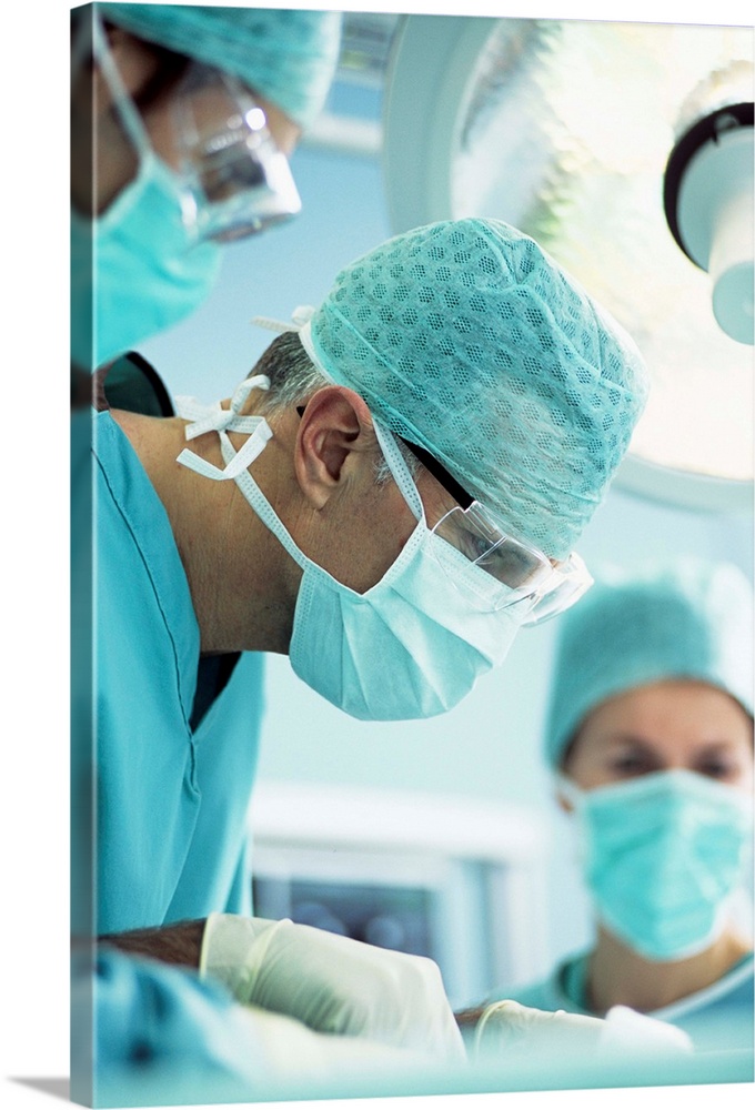 MODEL RELEASED. Surgeon performing an operation.