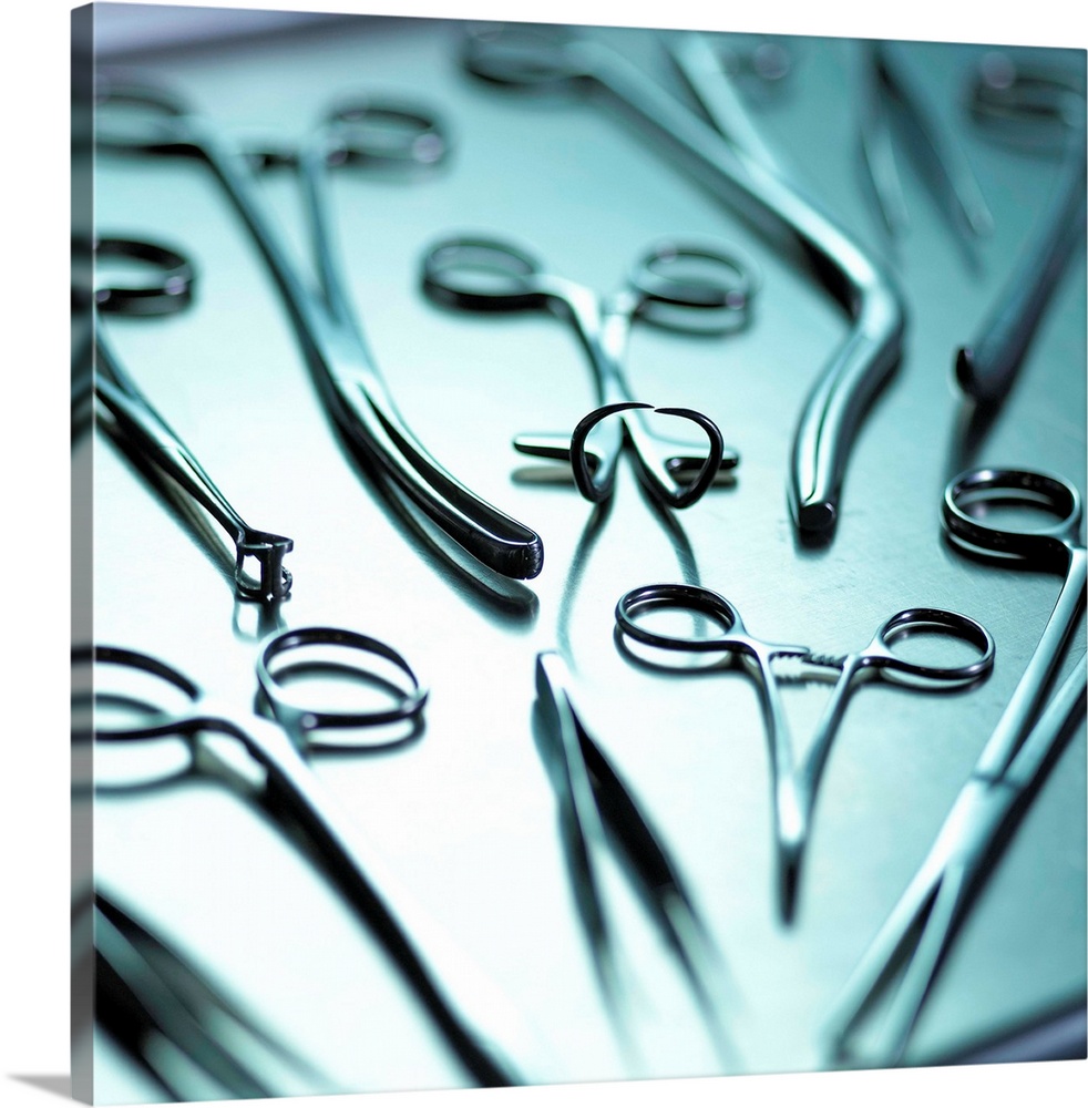 Surgical equipment. Metal forceps, tweezers and scissors on a tray. These instruments are used for surgical operations.