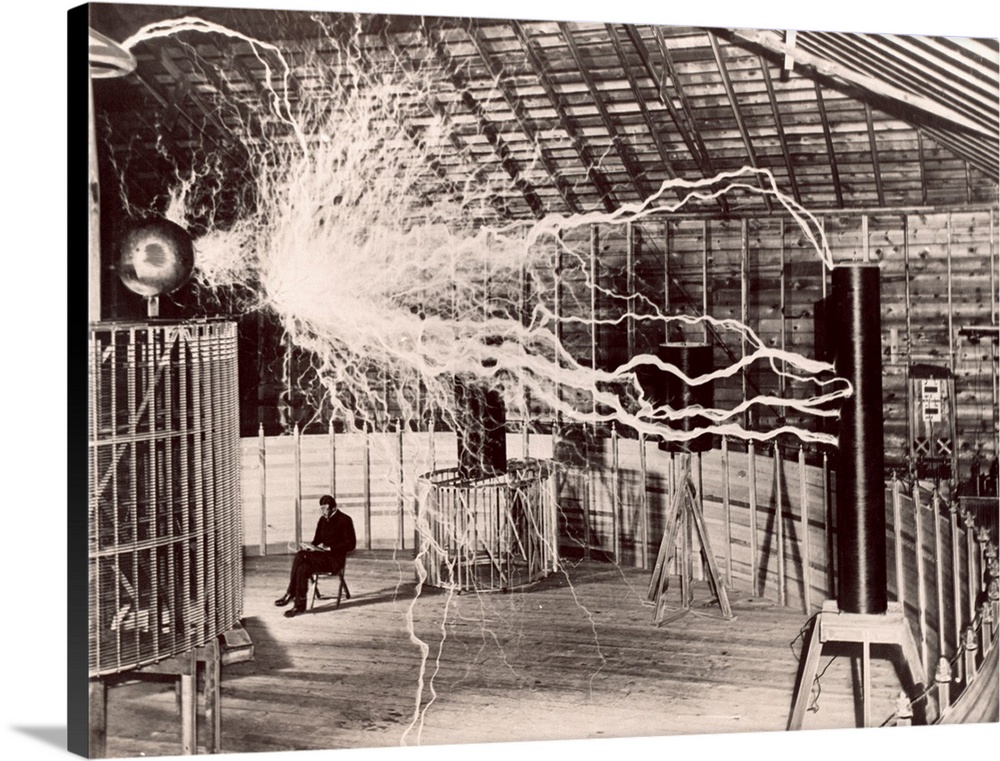 Tesla coil experiment. Electrical streamers sparking outwards from a large Tesla coil at left to another one at right, at ...