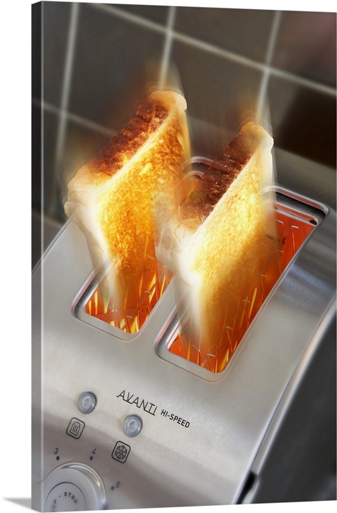 Toast. Toasted slices being ejected from a stainless steel toaster.