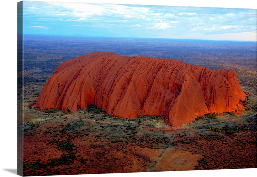 Uluru (Ayers Rock) at sunset. Uluru is a large sandstone rock formation in the southern part of the Northern Territory in ...