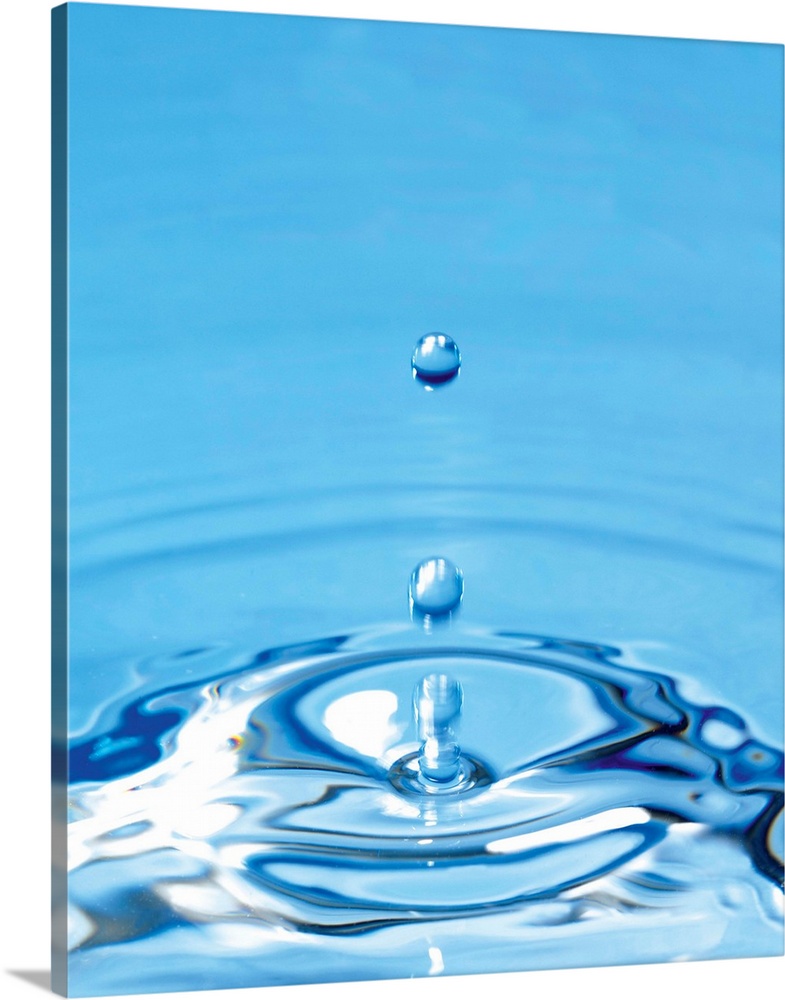 Water drop impact. High-speed photograph of secondary drop formation following the impact of a water droplet on water. The...