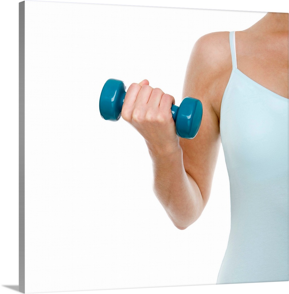 MODEL RELEASED. Woman lifting weights.