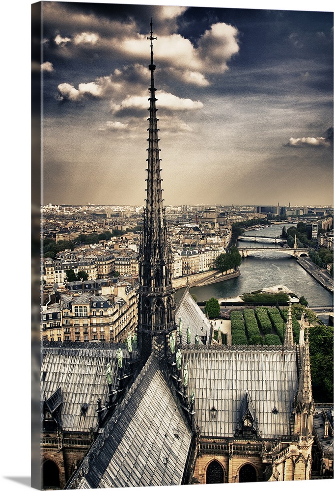 Fine art photograph of the top spire of the cathedral, overlooking the Seine river and the Ile-de-Paris on a cloudy day.
