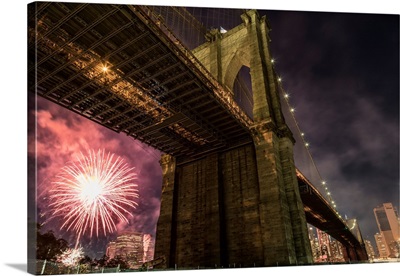 Brooklyn Bridge and fireworks over Manhattan in NYC