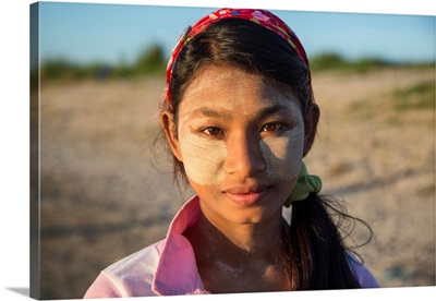 Burmese girl with facepaint at sunrise, Mandalay, Burma