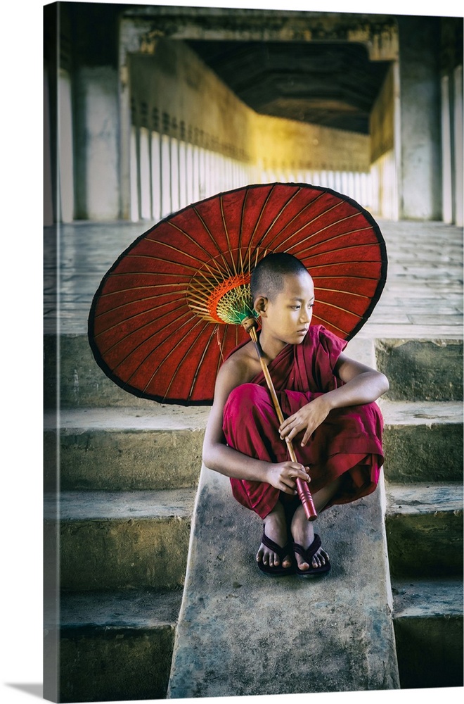 Burmese monk with parasol in his monastery