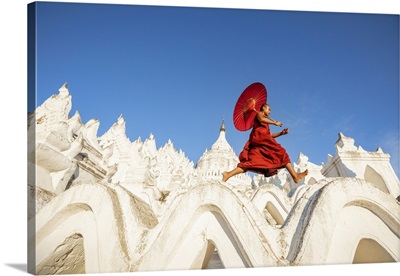 Burmese Monk With Parasol Walking At His Monastery In Mandalay