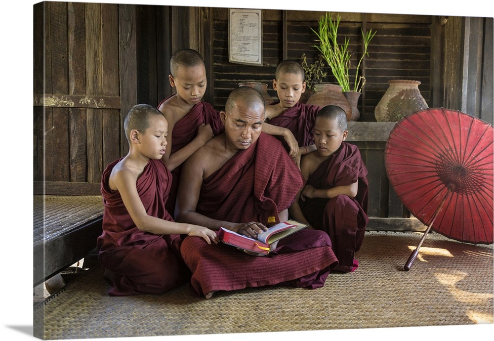 Burmese monkmaster and young monks in their monastery