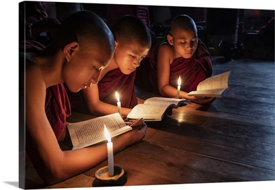Burmese Monks Reading By Candlelight In Their Monastery