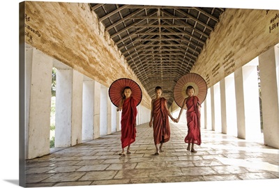 Burmese monks with parasols in their monastery, Mandalay, Burma