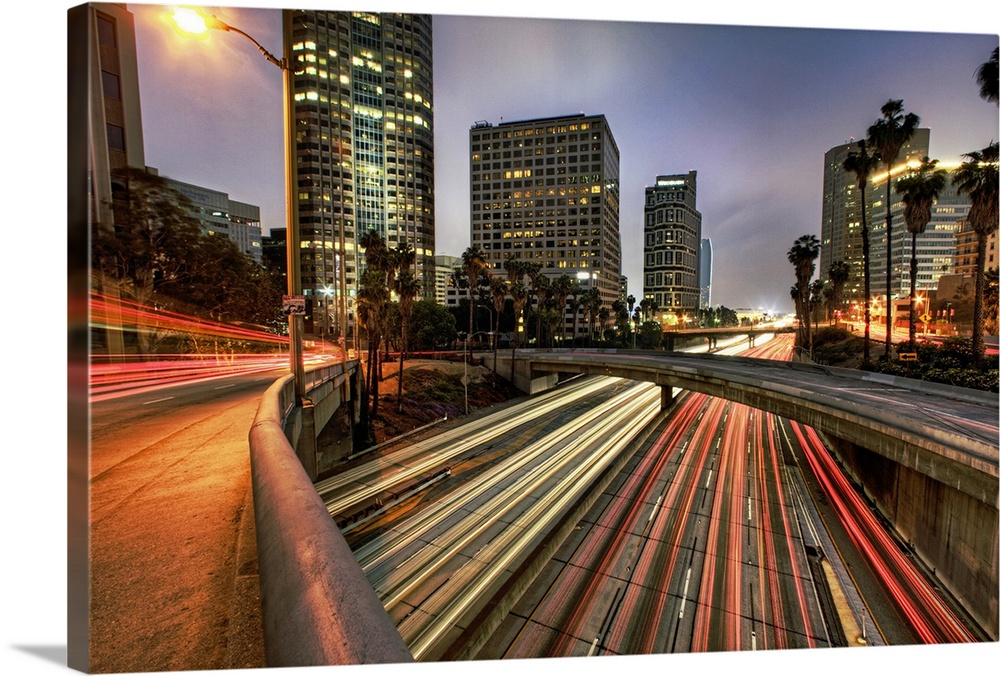 A large photograph of some of downtown Los Angeles with the lights of cars streaking through.