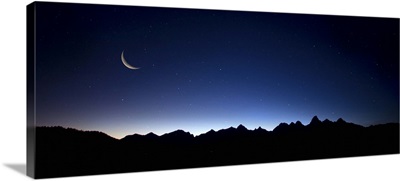 Crescent moon over the Grand Tetons in Jackson Hole, Wyoming