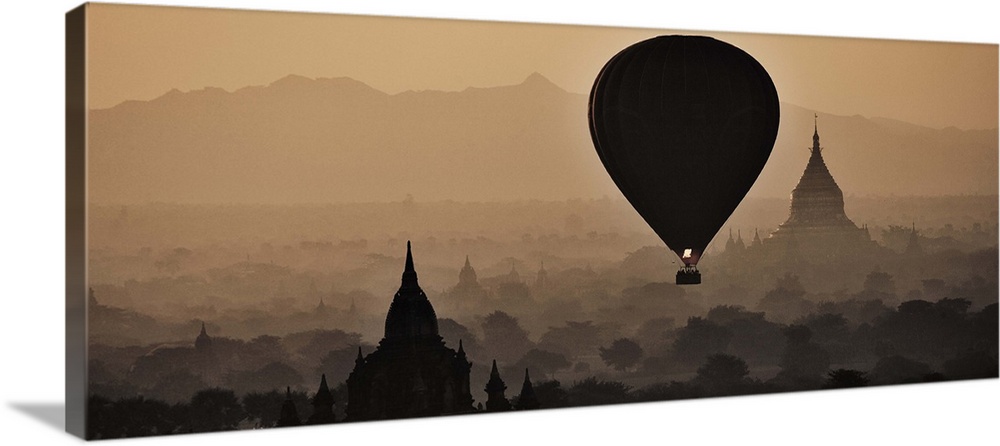 Hot air balloons floating above the temples of Bagan, Myanmar at sunrise