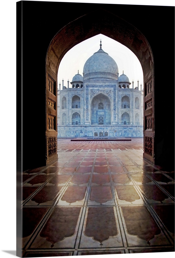 Photograph taken of the Taj Mahal through an archway.
