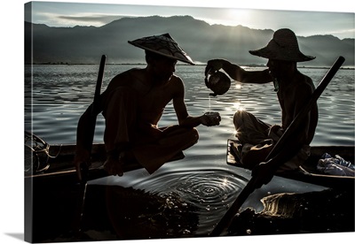 Inle Lake Fisherman pouring tea in their longtail boats in Burma