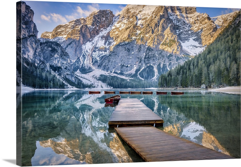 Lago di Braies and row boats at sunrise in the Dolomites