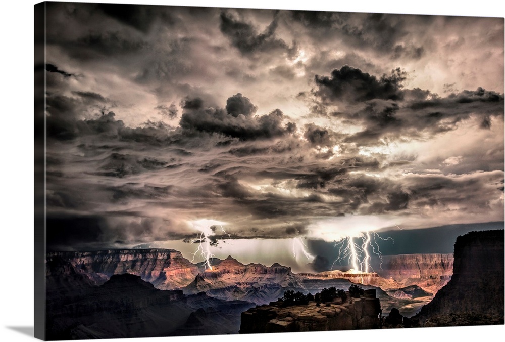 Photograph of lightning bolts striking gorge after sunset during a thunderstorm.