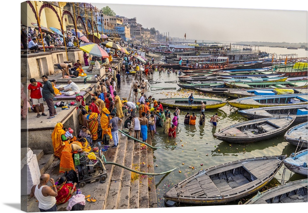 Longtail boats and people praying in the Ganges River, Varinasi, India
