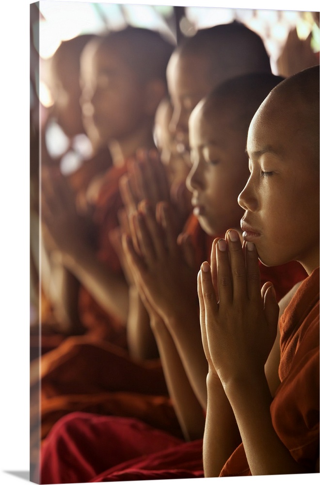 Monk boys in prayer in their monastery