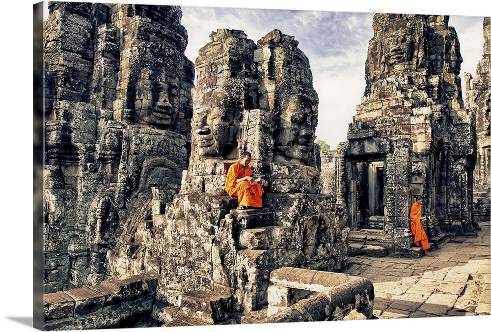 Monk boys reading on the Bayon Temple, Angkor Wat, Cambodia