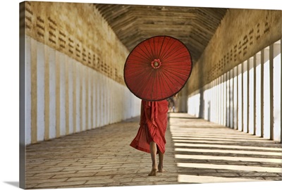 Monk with Parasol walking in Monastery, Bagan, Burma