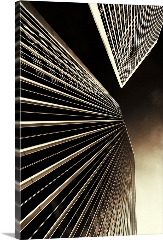Vertical photo on canvas of the view looking upwards at two tall skyscrapers.
