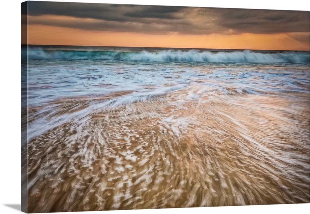 Sunset and waves crashing off the coast of Burma